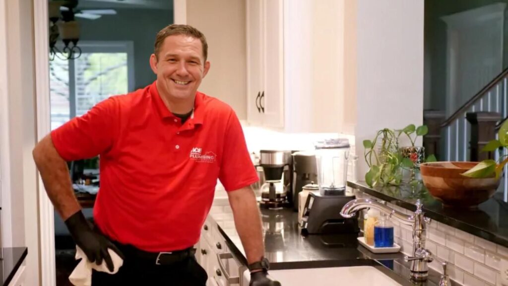 Plumber standing by a kitchen sink