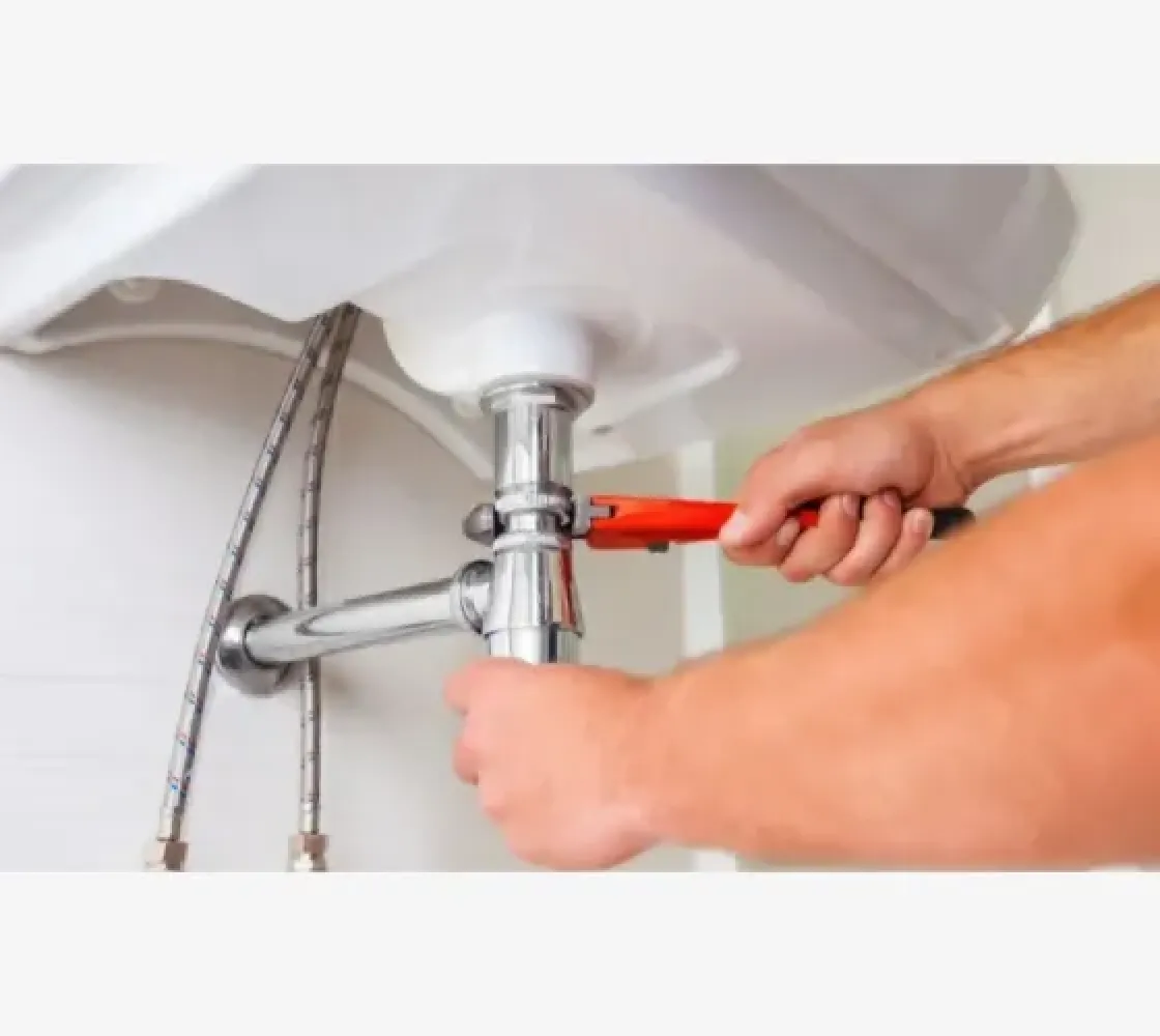 a person washing a sink