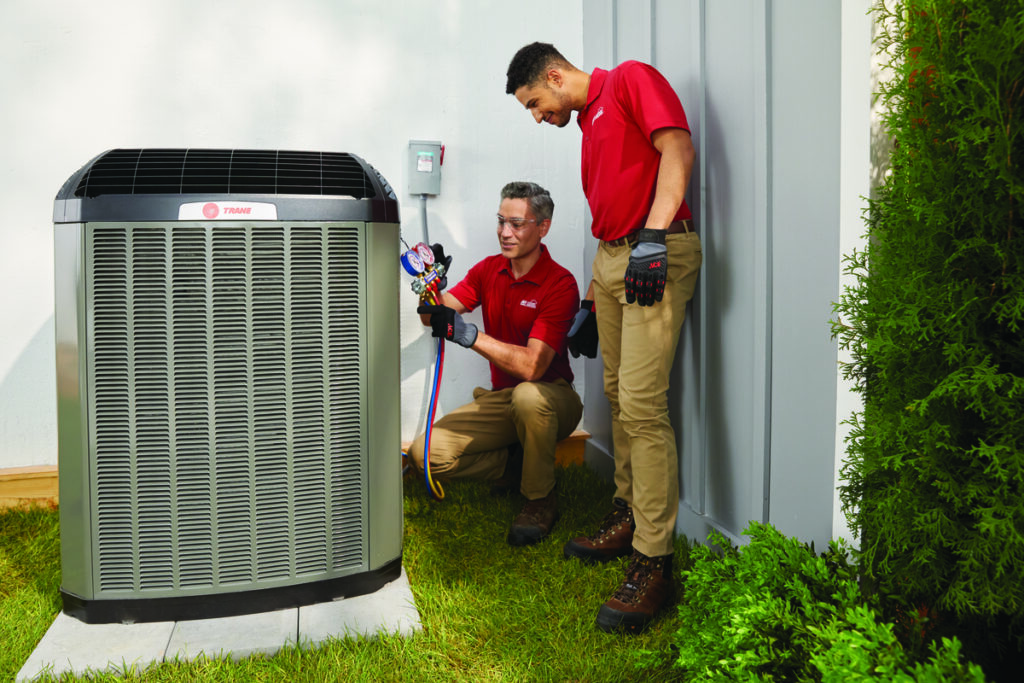 Technicians working on an air conditioner